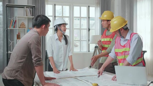 Three Asian Engineers With Helmets Sharing Ideas About Work To A Man At The Office, Angry Colleagues Debate Fight Over Paperwork 
