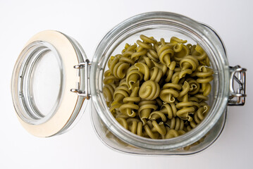 glass jar containing spinach fusilli pasta