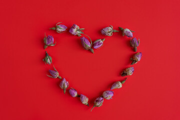 Heart of flowers on a red background.