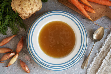 A plate of bone broth wth fresh vegetables