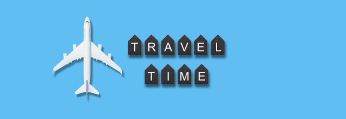Traveling concept , wooden cubes with TRAVEL TIME words and airplane model