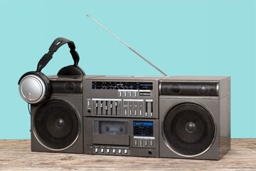 Retro portable cassette tape recorder on wooden table  Vintage old style boombox.