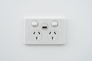 Socket with usb interface and switch on white wall