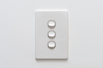 Three Gang white light switch on the wall