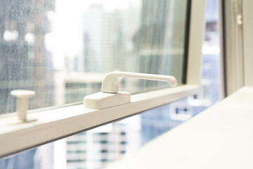 Closeup of open window and handle in modern apartment