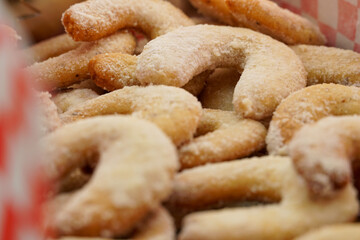 Macro shot of freshly baked vanilla crescents (vanillekipferl) covered with powdered sugar