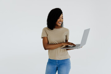 Happy afro woman using laptop isolated over white background