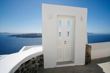Typical design white decoration door next to an alley with a breathtaking view of the volcano Nea...
