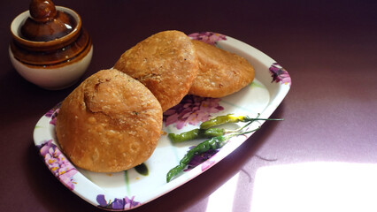 Kachori and samosa, Indian vegetarian snacks served with green and tamarind chutneys.