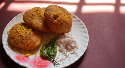 Kachori and samosa, Indian vegetarian snacks served with green and tamarind chutneys.