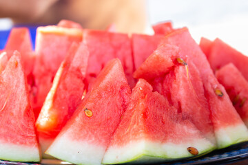 Ripe watermelon slices. Sweet tropical fruits. Juicy fruits. Triangle slices of watermelon. Healthy...