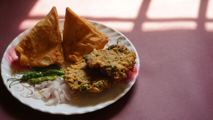 Kachori and samosa, Indian vegetarian snacks served with green and tamarind chutneys.