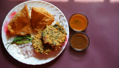 Kachori and samosa, Indian vegetarian snacks served with green and tamarind chutneys.
