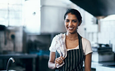 The queen of the catering industry. Portrait of a confident young woman standing in the kitchen of her cafe.