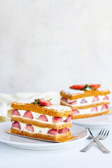 Strawberry cake slice on a white background. Layered cake with cream and strawberry. close up