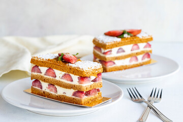 Strawberry cake slice on a white background. Layered cake with cream and strawberry. close up