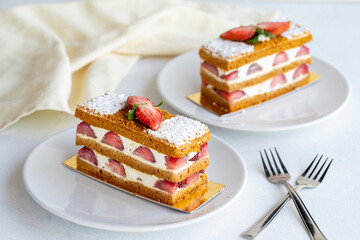 Strawberry cake slice on a white background. Layered cake with cream and strawberry. close up