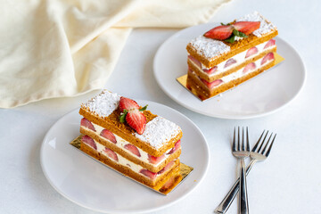 Strawberry cake slice on a white background. Layered cake with cream and strawberry. close up