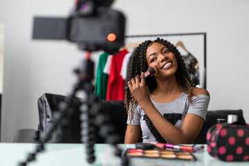 Portrait of black blogger woman review giveaway make up gift to fan following channel while...