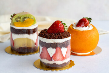 Assorted mini cakes with fruit on a white background. close up
