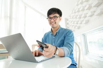 man work using typing computer texting cell phone.student study education online learning.adult professional chatting on laptop,mobile contact us at Thinking business plan.connecting people concept