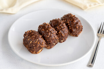 Chocolate petit four cake on a white background. close up