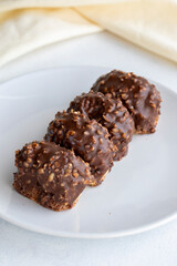 Chocolate petit four cake on a white background. close up
