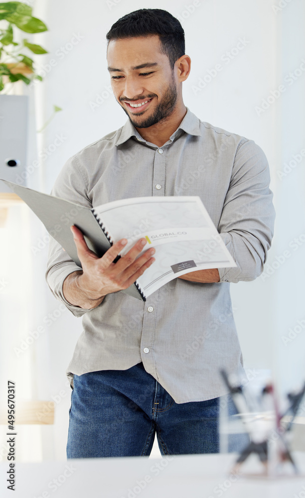 Aufkleber the numbers are looking good this month. shot of a young man reading a document at work in a modern 