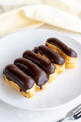 Chocolate eclairs cake on a white background. close up
