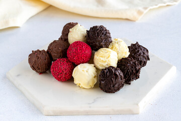 Truffle chocolate assortment on a white background. homemade chocolate pralines. close up