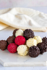 Truffle chocolate assortment on a white background. homemade chocolate pralines. close up