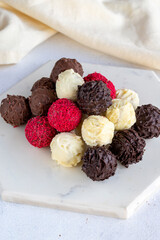 Truffle chocolate assortment on a white background. homemade chocolate pralines. close up