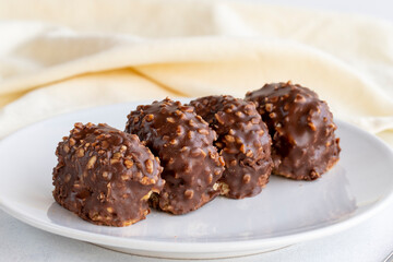 Chocolate petit four cake on a white background. close up