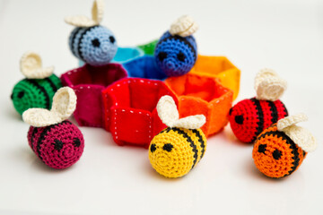 Colorful beehive with bees. Crochet safe toys for babies. Processed egg craft ideas are a bright Easter-colored rainbow-colored educational toy. Preschool game for young children. Montessori education