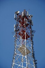 gsm antenna. scaffolding that supports gsm antennas. photo during the day.