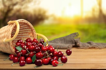 Fresh ripe cherries on a wooden table on natural background