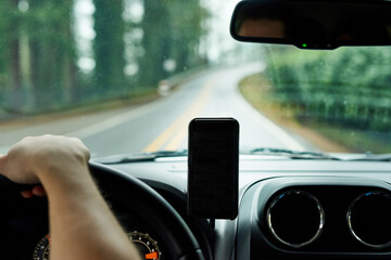 I know exactly how long this drive will take take me. Cropped shot of a man using his phones gps...