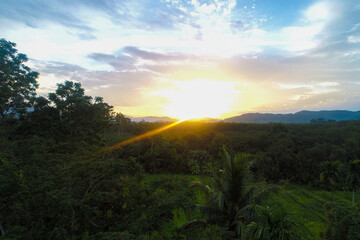 Aerial view mountain sunrise in tropical forest with cloud