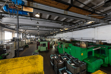 Photo of modern automatic automobile manufacturing workshop. Factory with steel constructions. Plant of car production. Industrial scenery background. Yellow and green