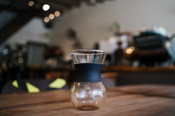 Empty classic pour over glass coffee with cafe background