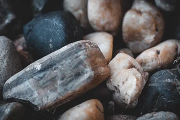 Fotobehang Closeup of big grunge stone on a small pebbles stones © Canyon Rodriguez/Wirestock Creators