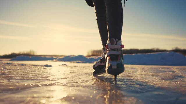 skate on the river. child playing on the river in winter. close-up legs child skating on ice in winter on the river nature. happy family lifestyle kid dream concept. figure skating in winter