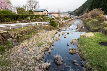 Fototapeta na wymiar Small glen running between some houses in a residential area of ​​Nikko, Japan.