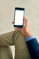All the data he needs to get things done. Cropped shot of a businessman using a mobile phone in an office.