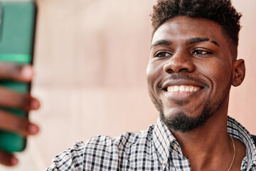 man with jacket over his shoulder taking a selfie