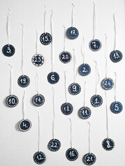 Advent calendar numbers hanging on the white wal