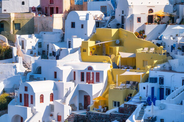 Oia village, Santorini, Greece. Architectural background. View of traditional houses in Santorini. Small narrow streets and rooftops of houses and hotels. Travel and vacation photography.