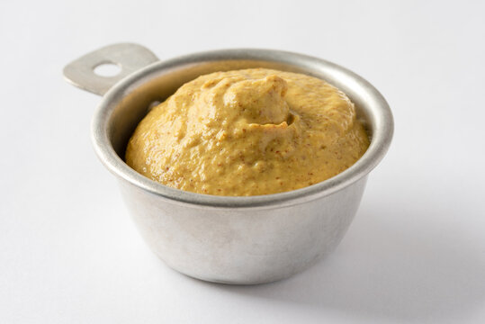 Spicy Brown Mustard in a Measuring Cup