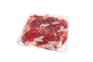 Slices raw beef in white plastic on white background.