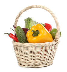 Fresh ripe vegetables and fruit in wicker basket on white background